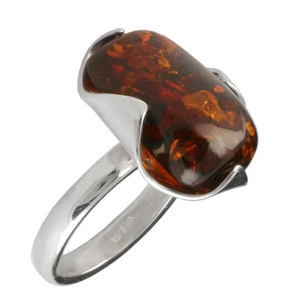 The 20mm x 13mm piece of Baltic amber is nestled in the handmade silver ring