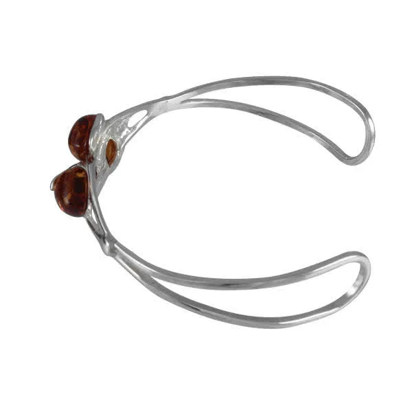 Each sterling silver bud is set with a piece of oval shaped Baltic amber
