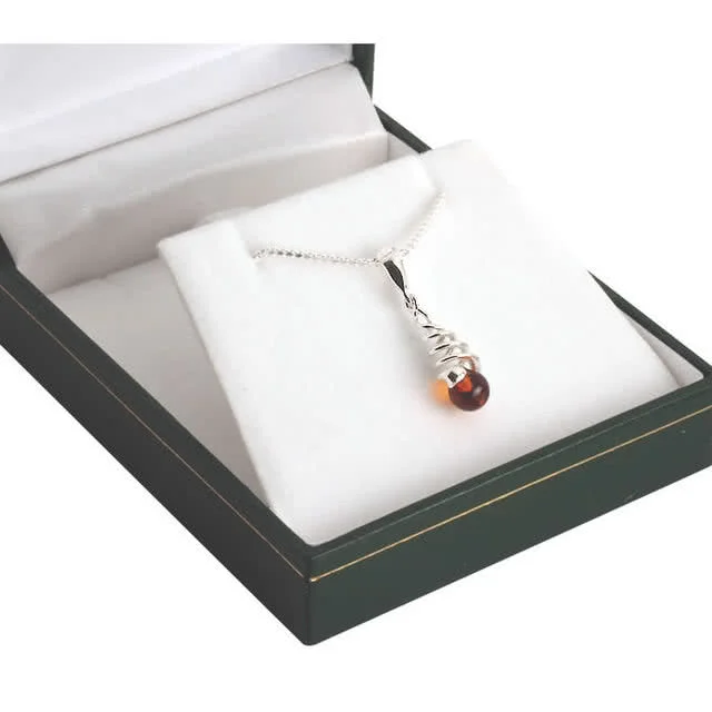 Alluring spiral design pendant with a genuine baltic amber bead