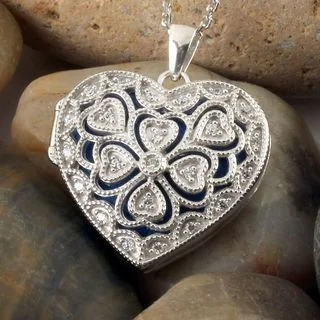 This silver heart opening locket can house two photographs