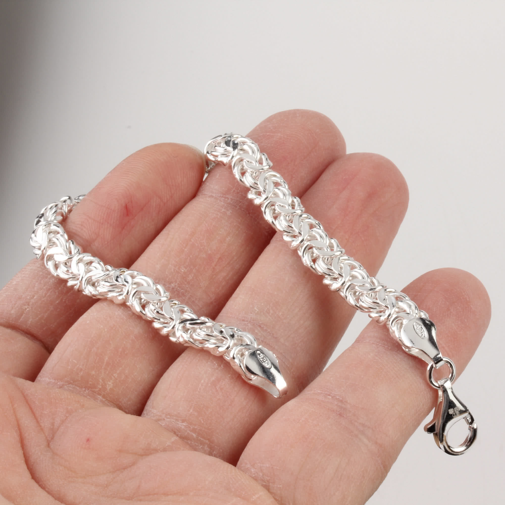 Ladies Byzantine Diamond Cut Bracelet shown close up in hand