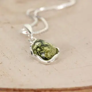 Wavy Edge Sterling Silver Pendant Set With Green Baltic Amber